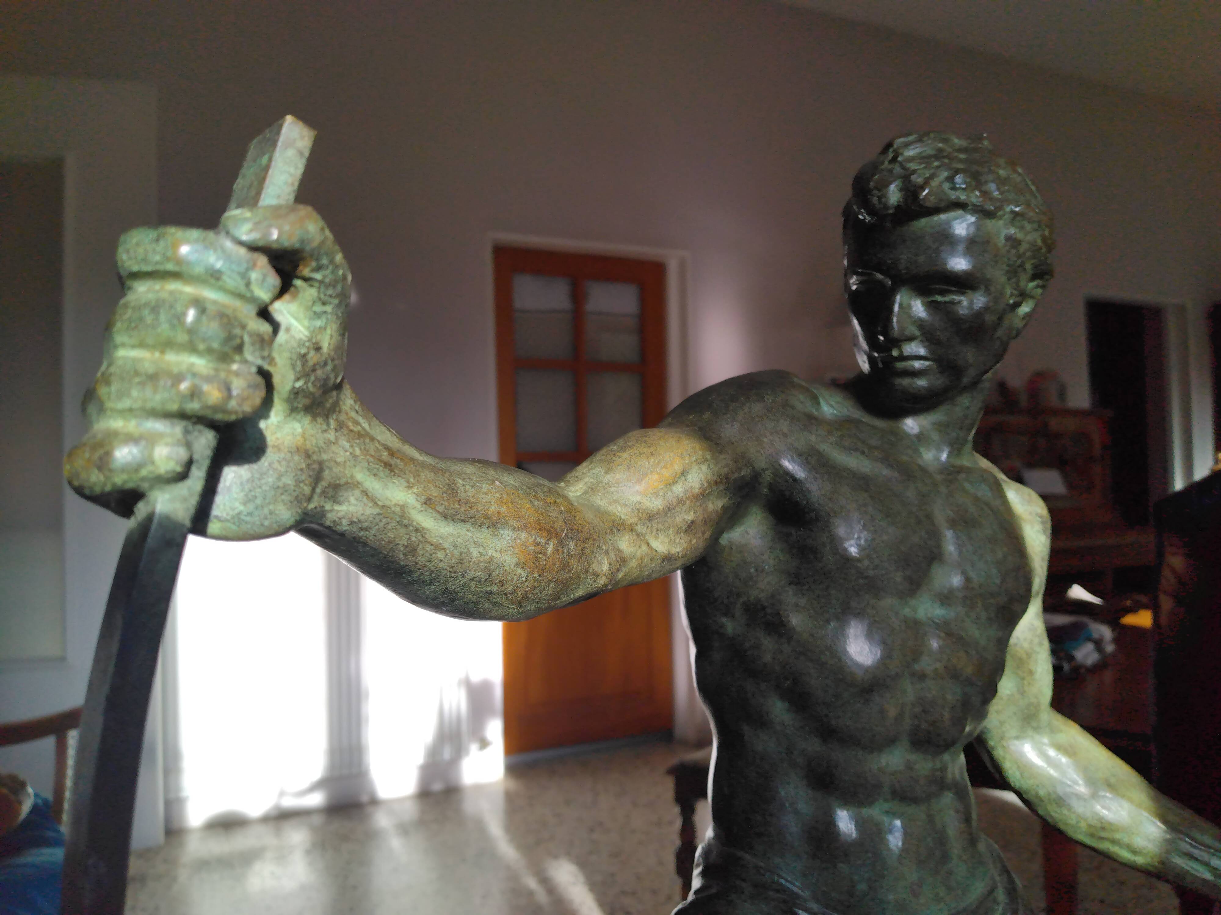 bronze sculpture athlete bending an iron bar by Jean de Roncourt on an art deco marble base