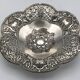 Silver-plated metal pocket emptier with openwork outline decoration