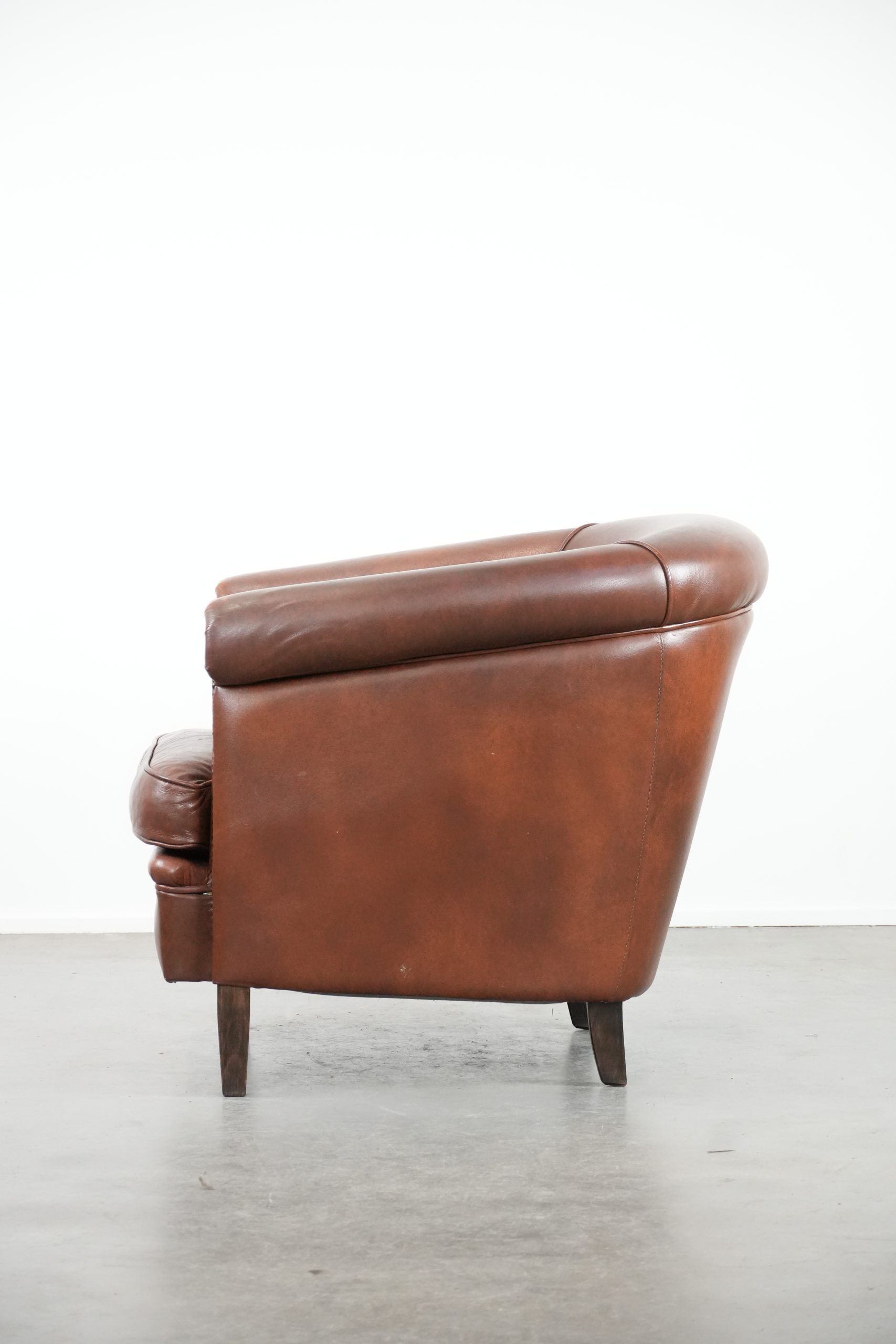 Cognac-coloured cow leather club armchair in English style