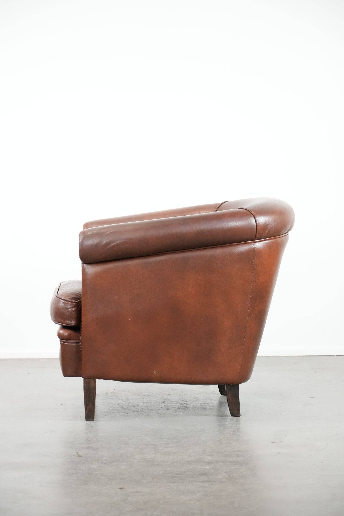 Cognac-coloured cow leather club armchair in English style
