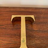 Golden sign letter “T”
