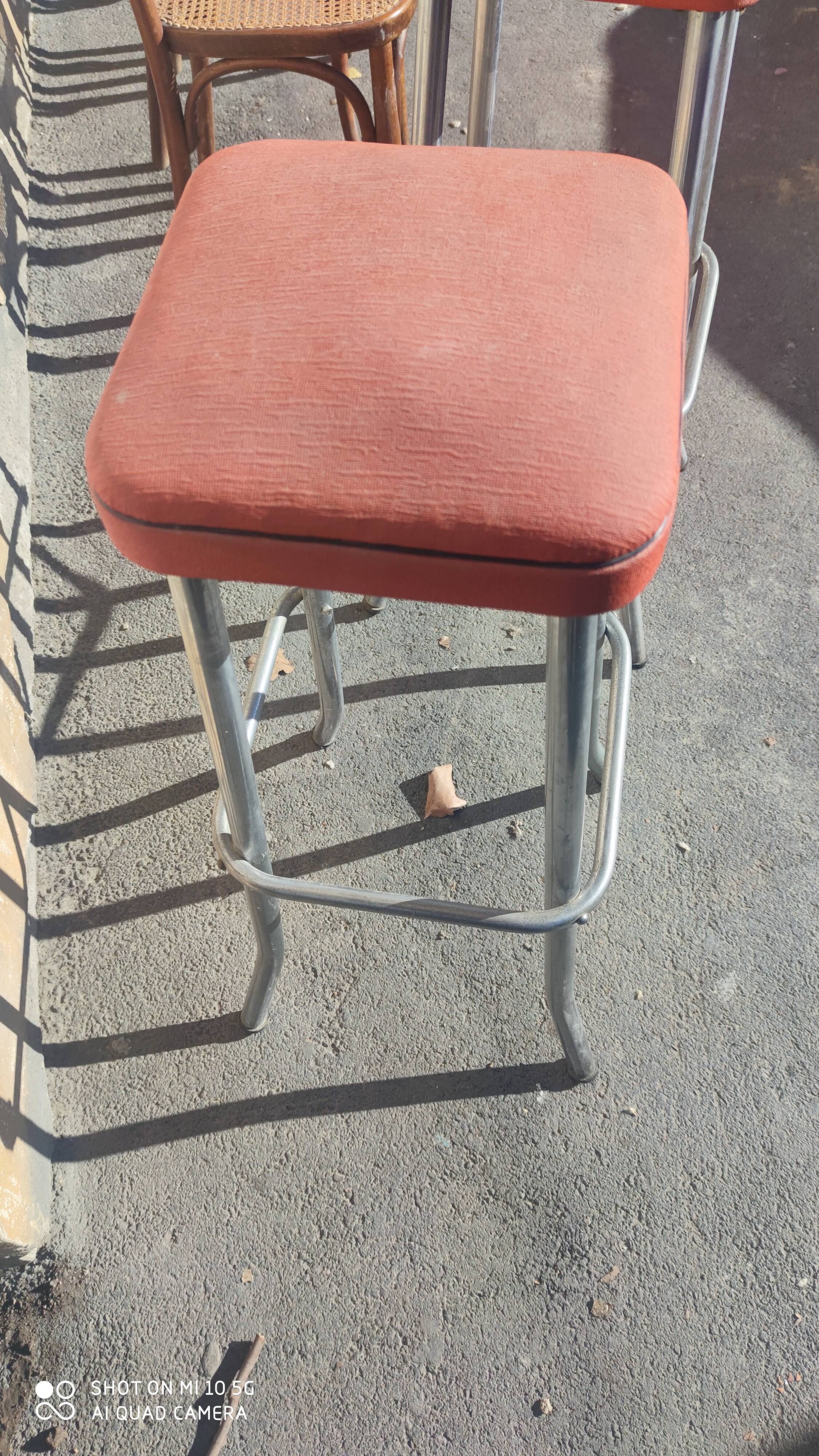 Pair of aluminum bar stools with orange and black seats