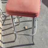 Pair of aluminum bar stools with orange and black seats