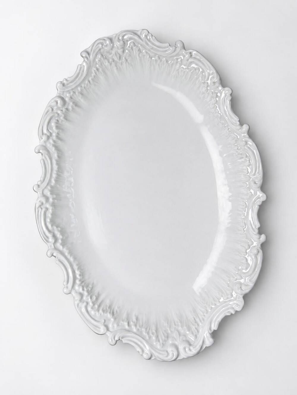 Antique deep dish in white Limoges porcelain, with rockwork relief.