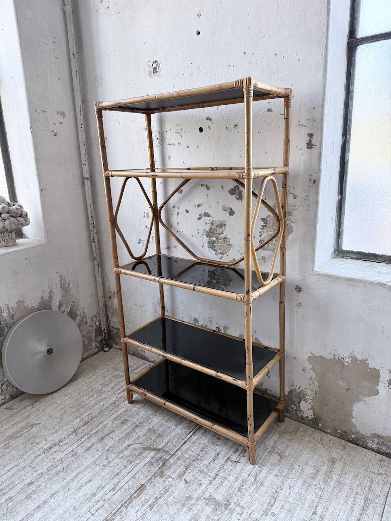 Rattan bookshelf and black glasses