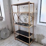Rattan bookshelf and black glasses