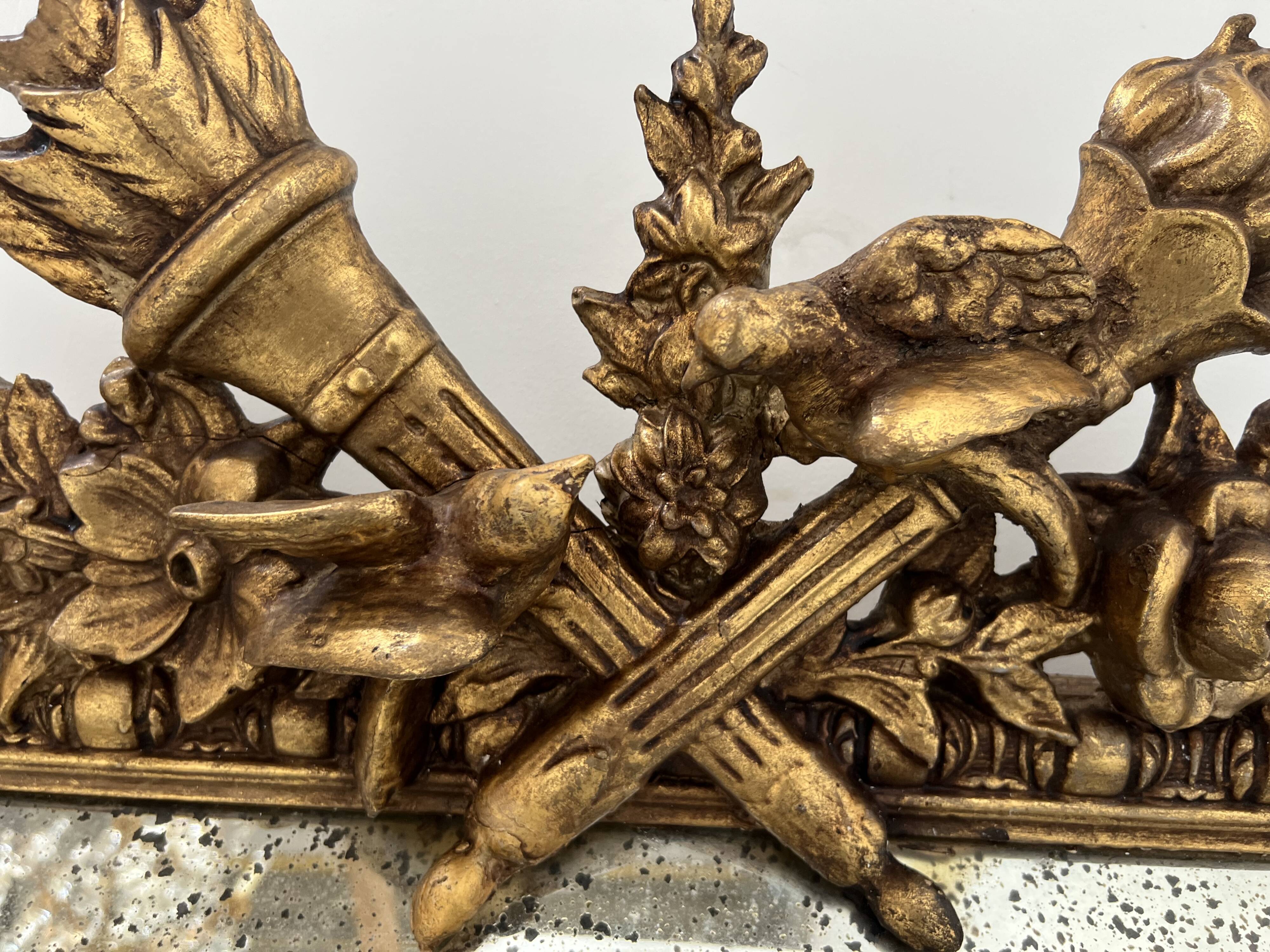 Louis XVI style mirror with parecloses in wood and gilded stucco, 19th century