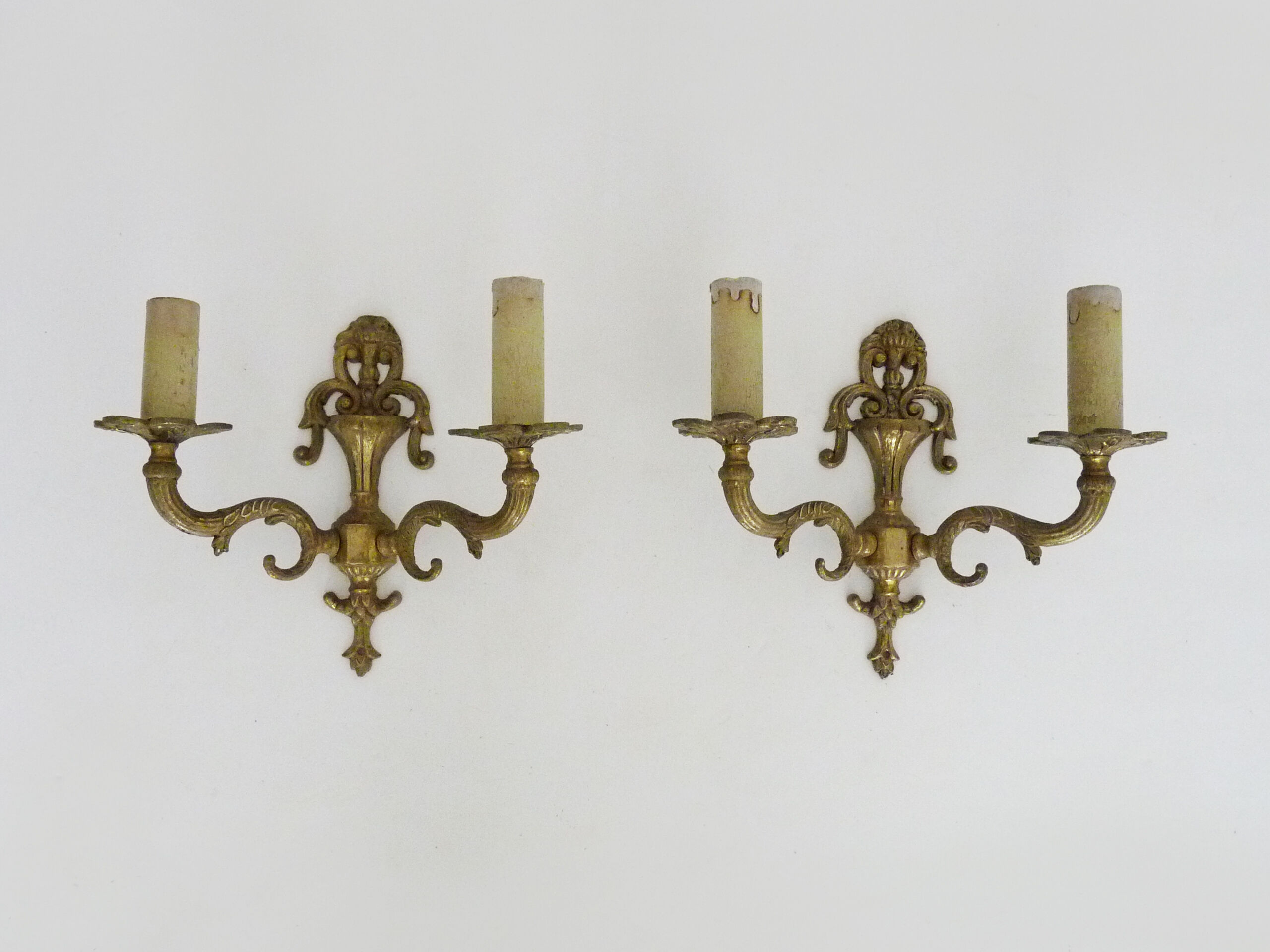 Pair of two-armed fire pot wall lights in gilded bronze.