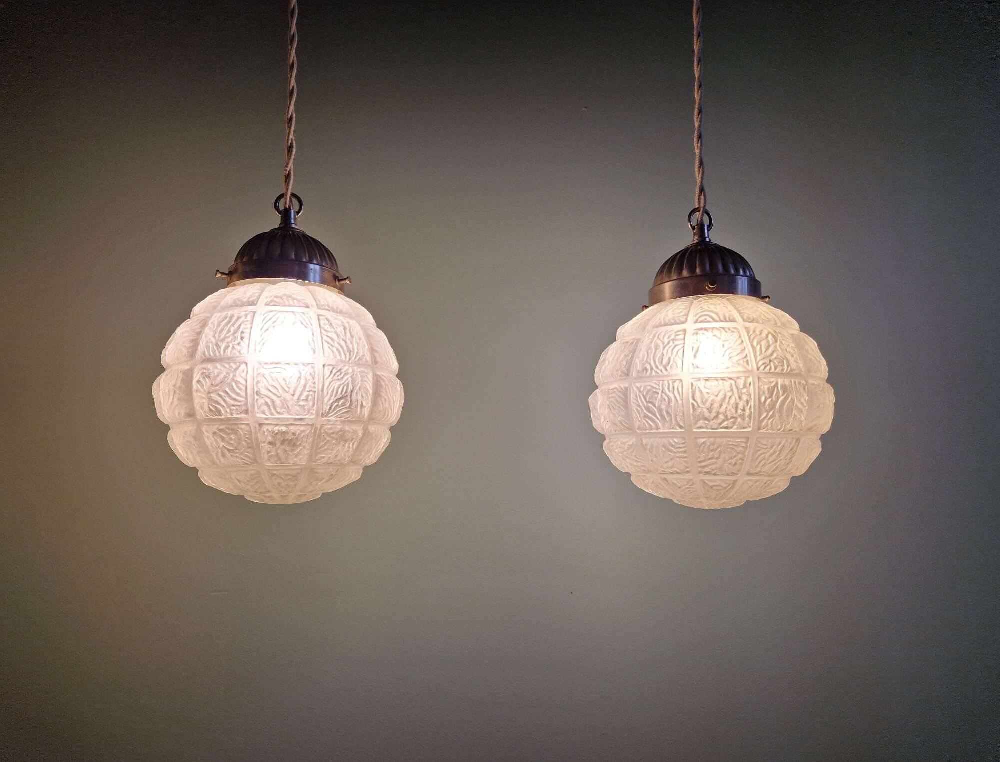 Art Deco trio of frosted glass pendants, 1920s-30s.