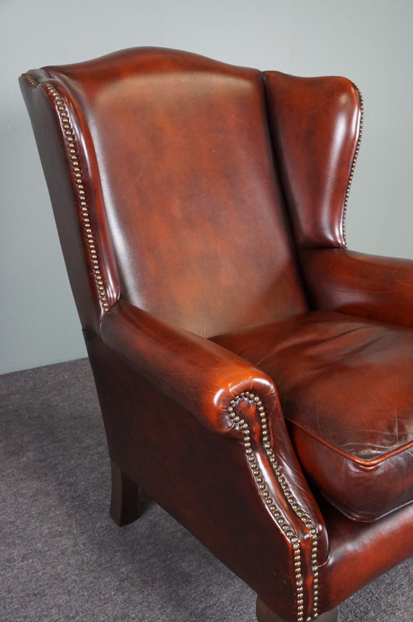 Leather armchair with decorative nails