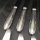 9 table knives in silver metal.