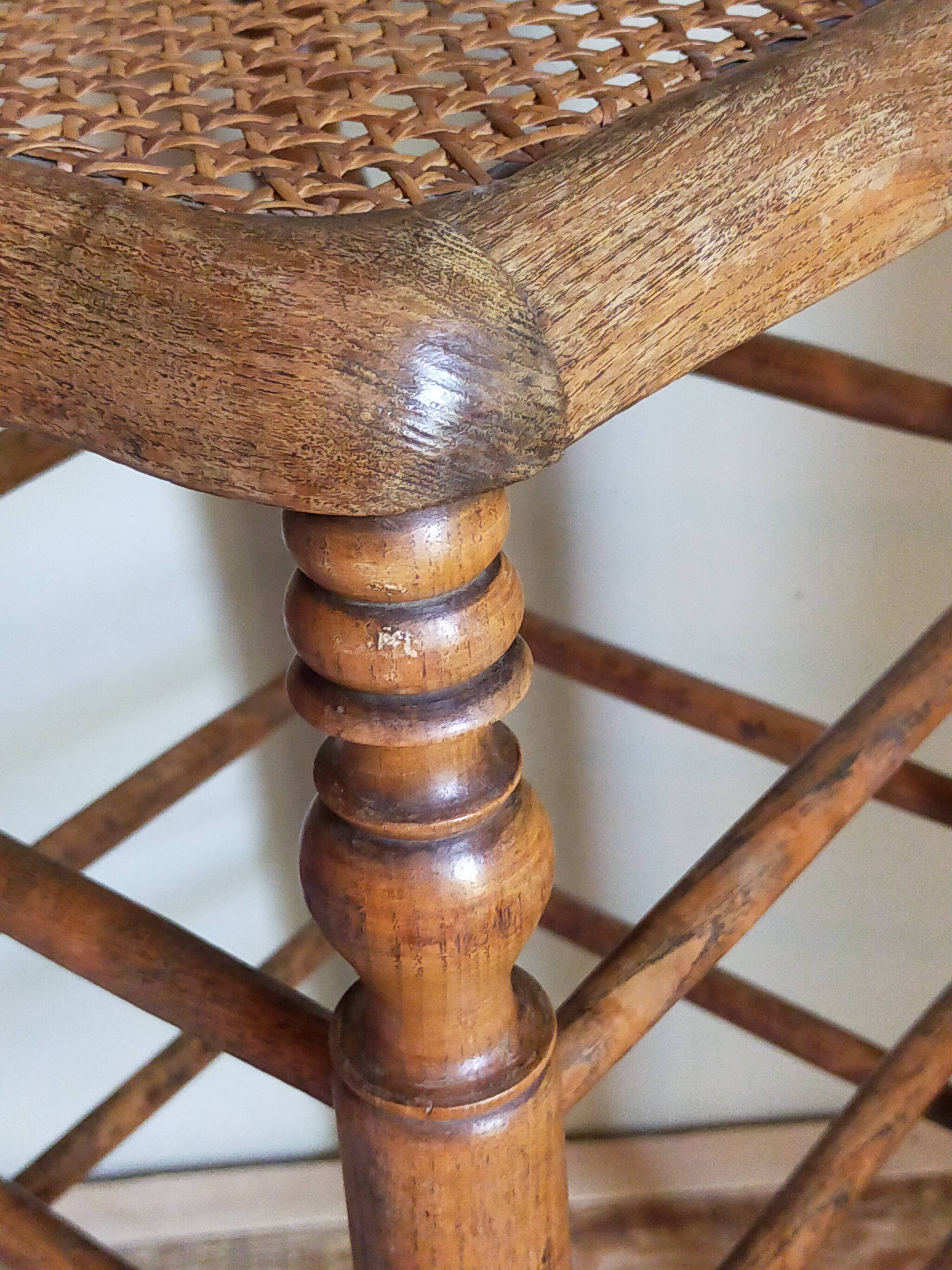 Antique stool with cane and turned wood