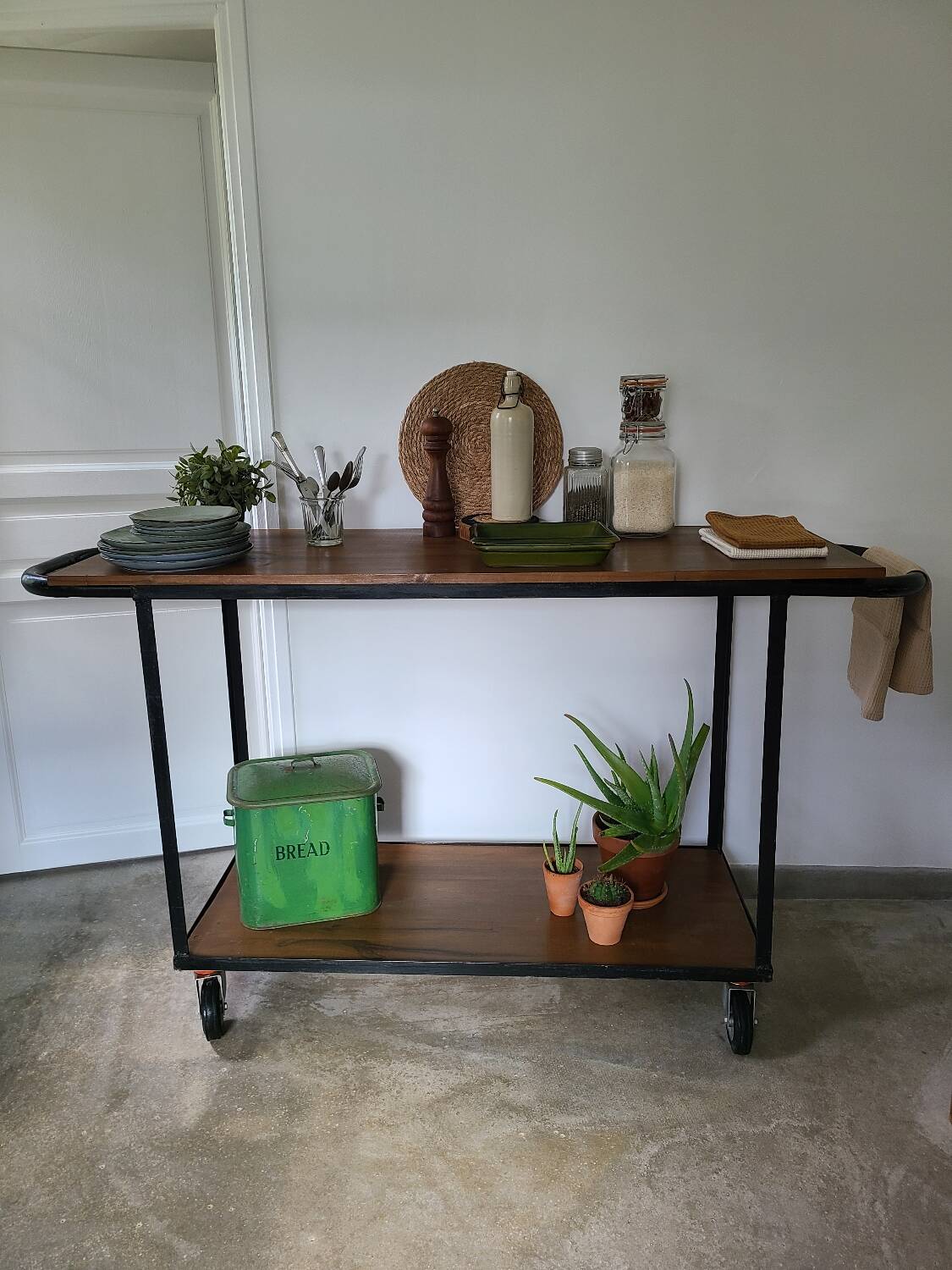 Large central kitchen island trolley on wheels serving industrial console