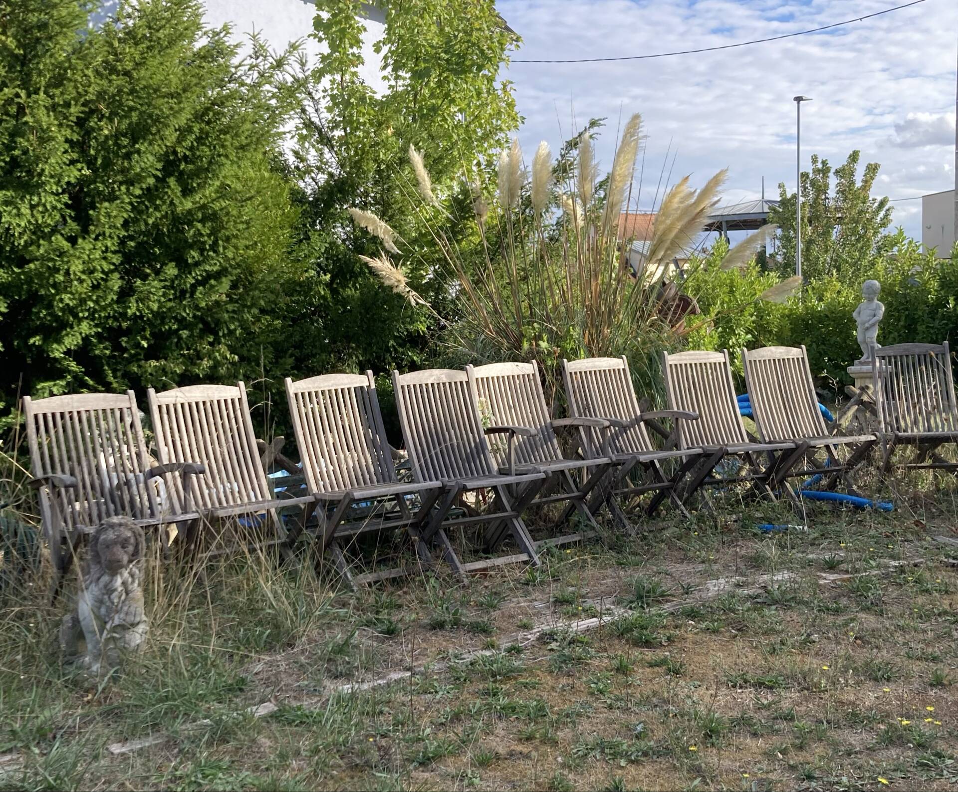 Folding garden chairs and armchairs in River Han dowelled teak.
