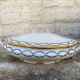 Old soup bowl with a golden border and decorated with small blue flowers