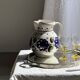 Very large vintage ceramic carafe in white glazed with blue floral decoration.