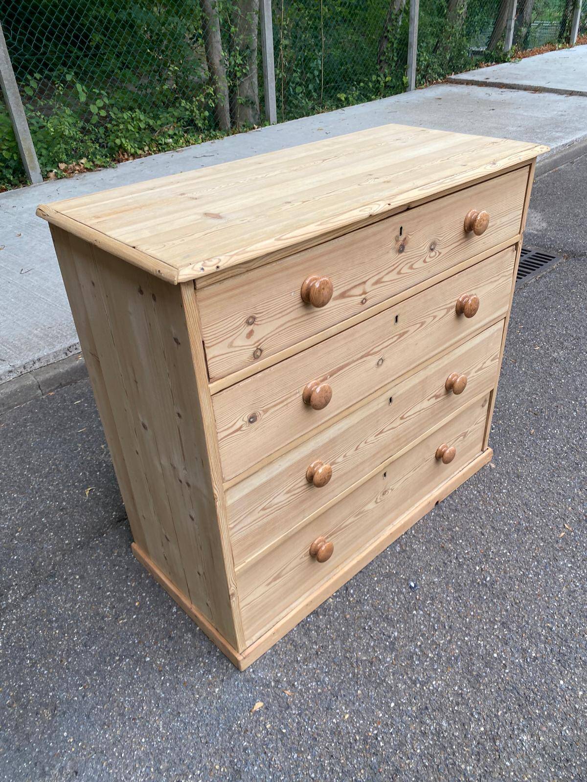 Victorian commode from the 19th century stripped to raw solid wood with ceramic knobs.