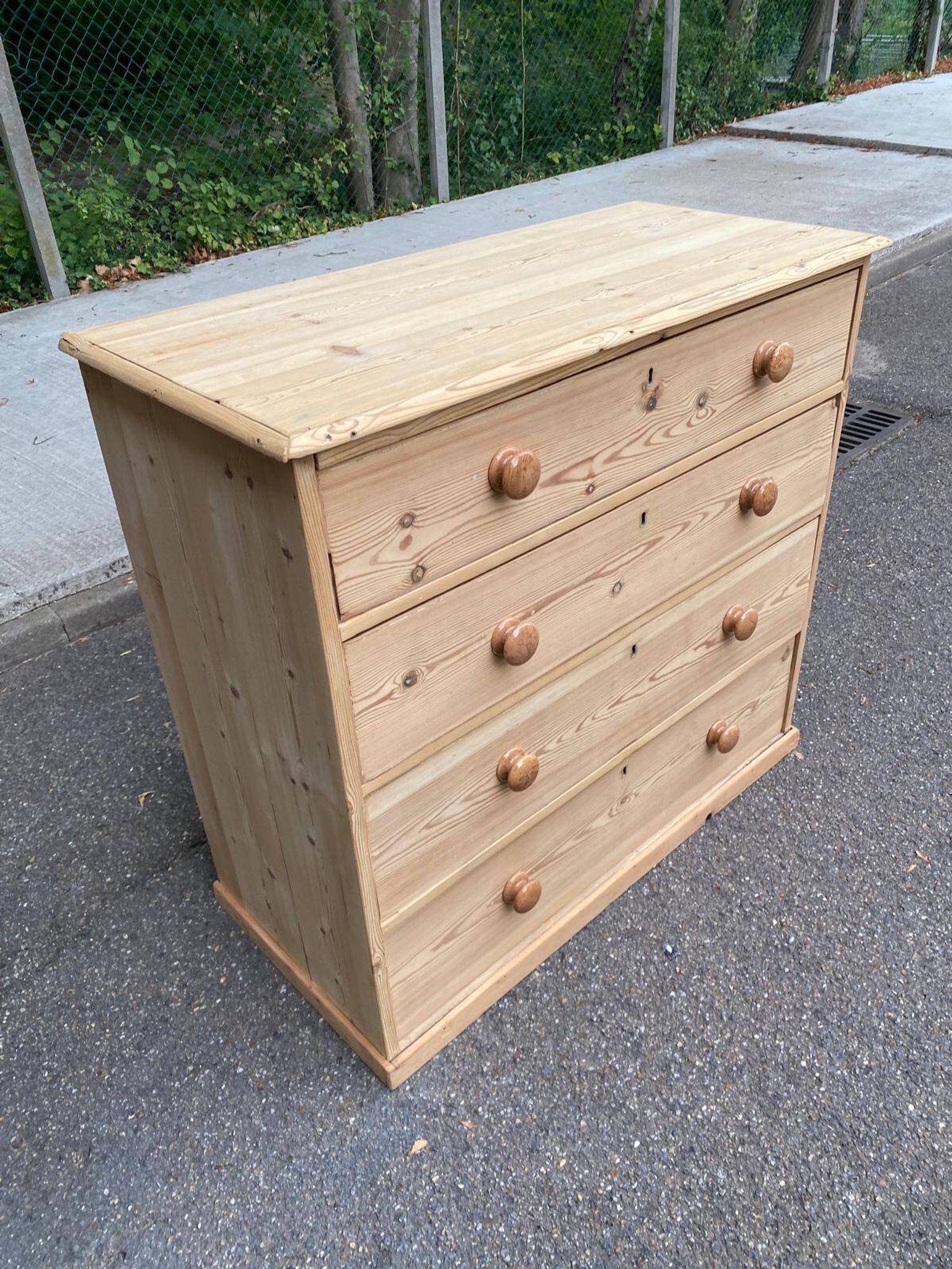 Victorian commode from the 19th century stripped to raw solid wood with ceramic knobs.