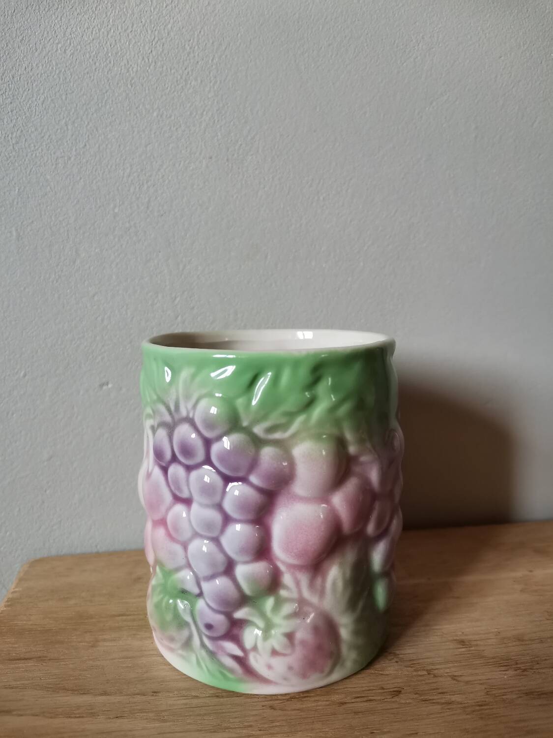 Vintage ceramic cup with vintage fruit pattern, pastel tone