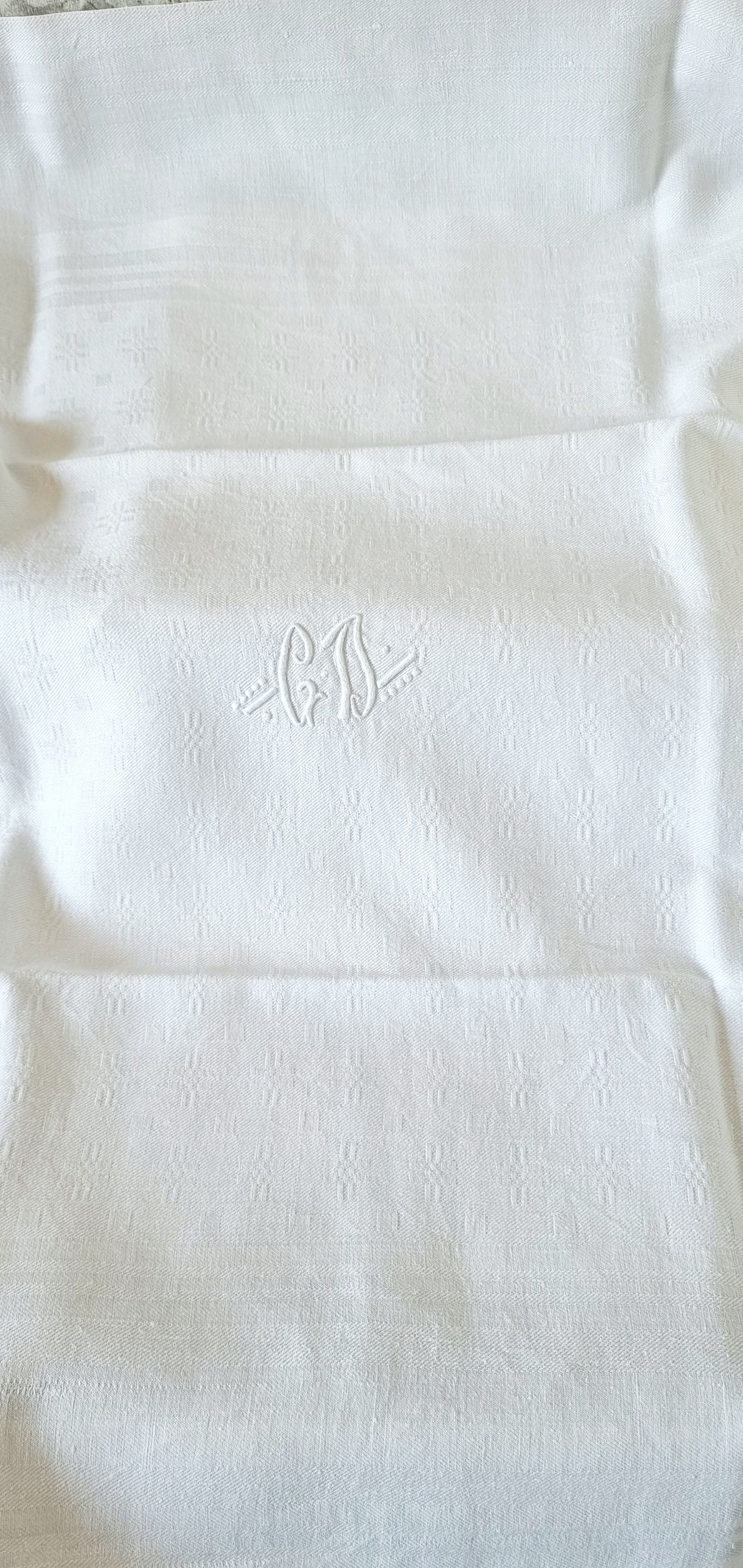 12 antique French linen towels with damask embroidery with "GB" anagrams.