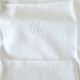 12 antique French linen towels with damask embroidery with "GB" anagrams.