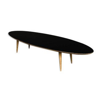 Oval coffee table with a black tray and oak-turned feet