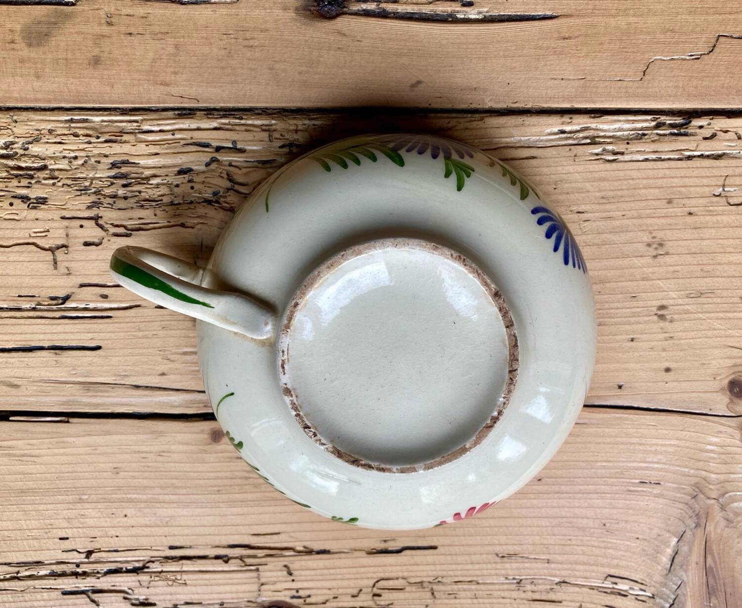 Large cup and saucer in the quimper earthenware style.