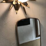 Vintage 1960s mirror in a freeform shape with a gold and red trim.