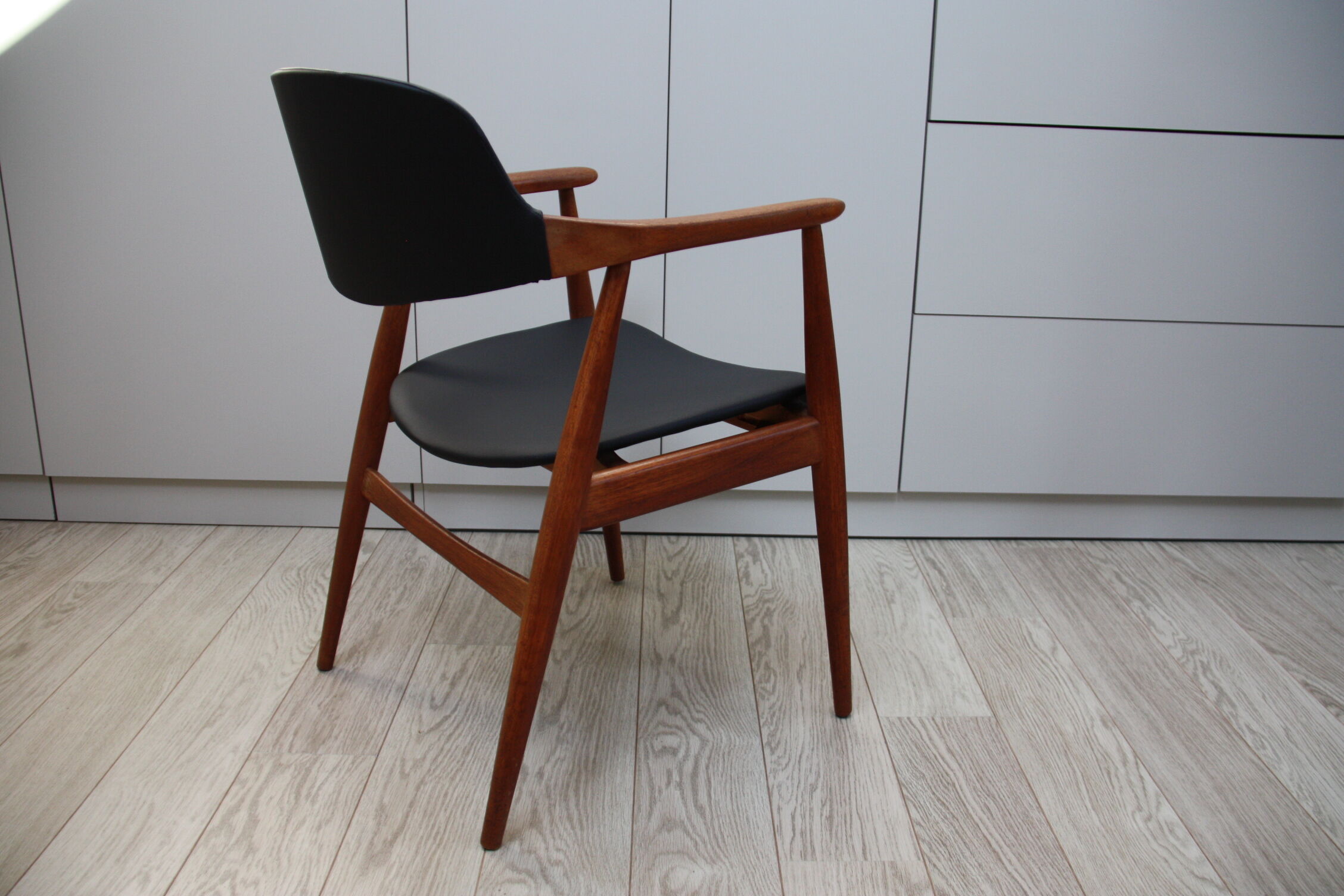 Vintage armchair in teak and black leather model Casina 60s