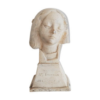 Bust of woman in plaster on pedestal with inscription