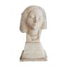 Bust of woman in plaster on pedestal with inscription