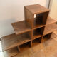 Low wooden shelf in 1960s brutalist style.