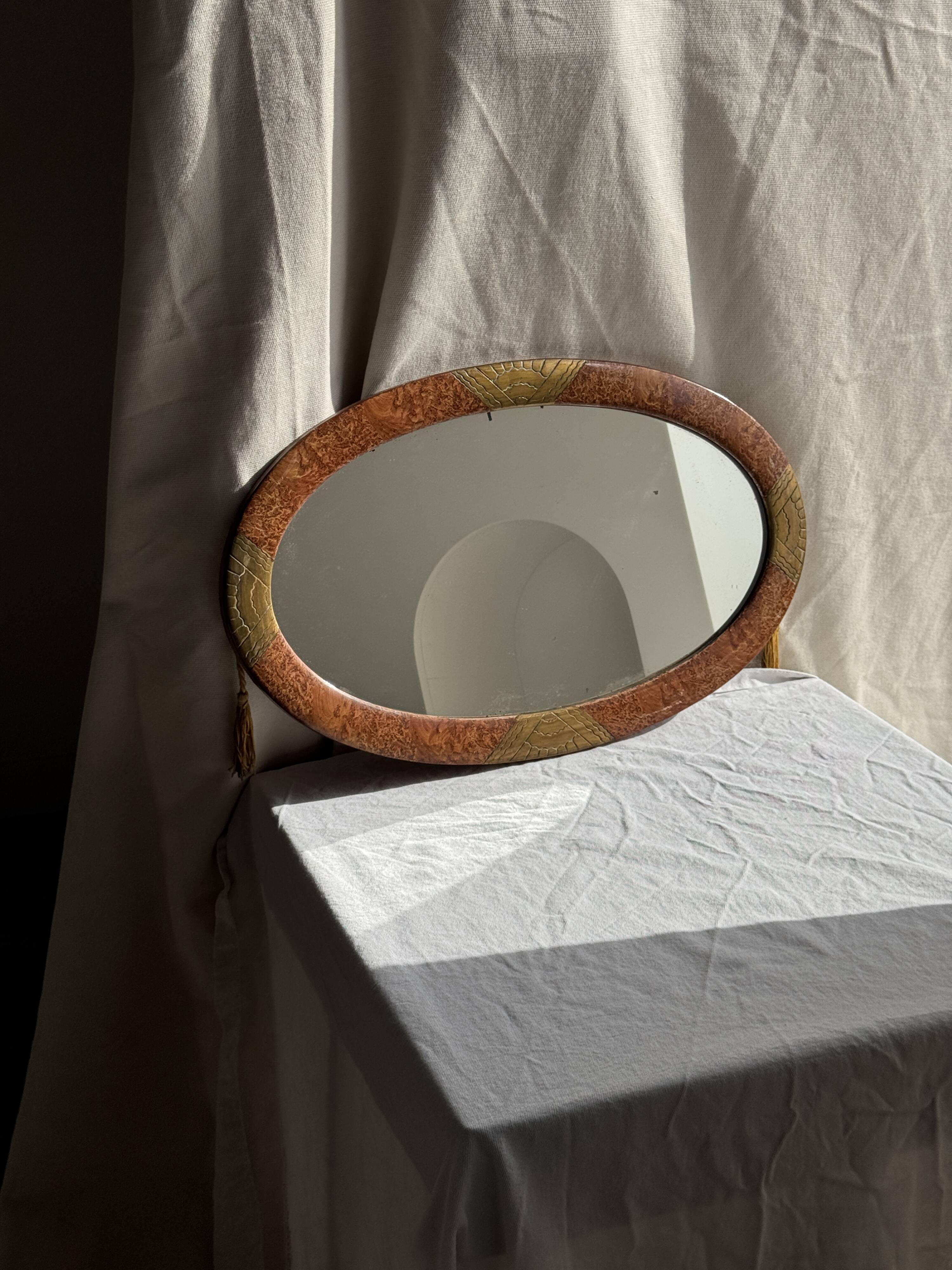 Small oval Art Deco mirror in brown and gold 33x54.