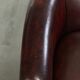 Vintage sheepskin club armchair with decorative nails and black piping