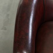Vintage sheepskin club armchair with decorative nails and black piping