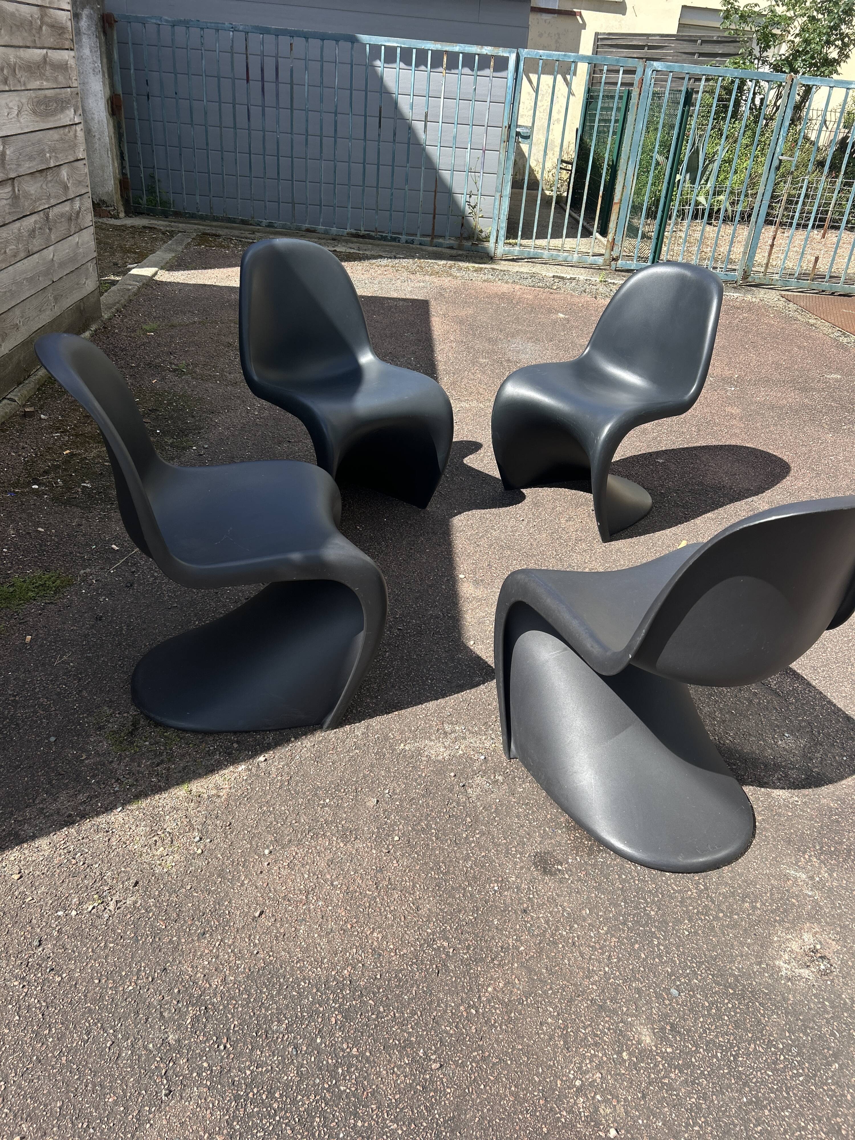 Set of 4 black Verner Panton Vitra chairs.