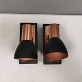 A pair of wall lamps from Eglo, in copper color and black.