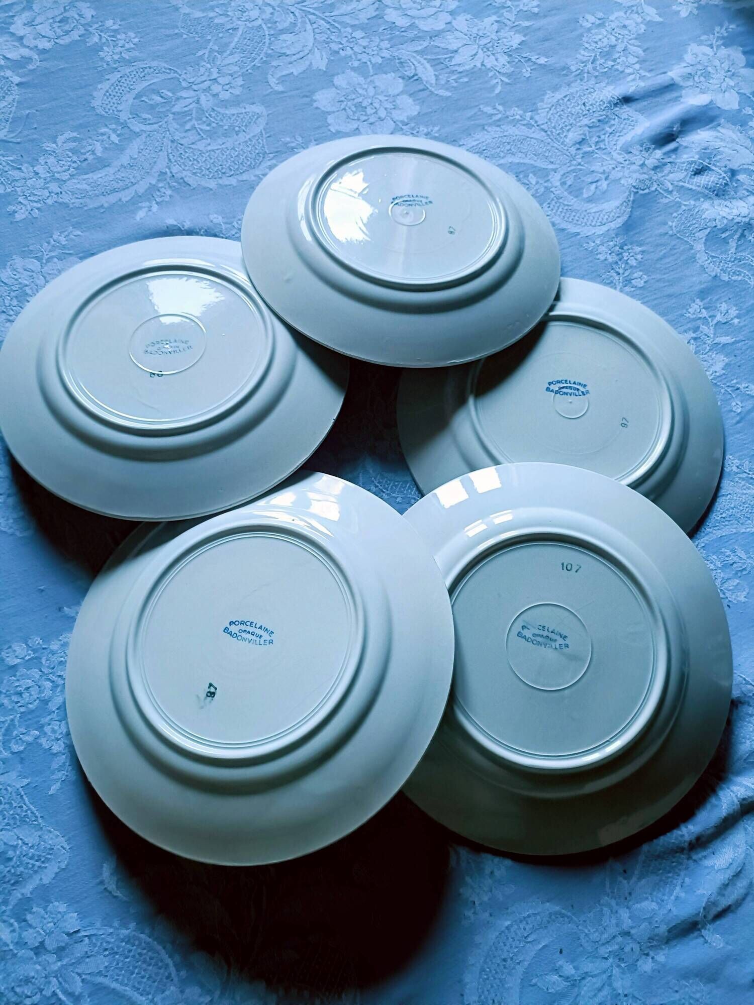 Five numbered opaque porcelain plates from Badonviller.