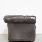Old dark brown 3-seater cowhide chesterfield sofa with lots of character