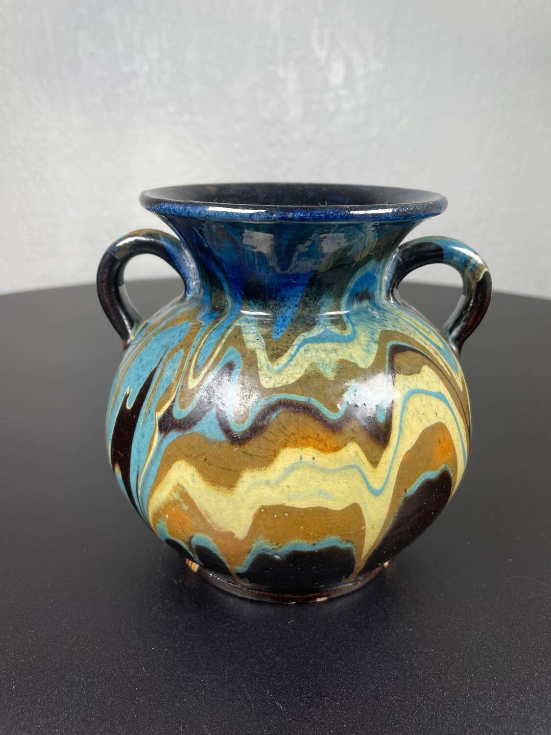 Black ball vase with handle, yellow blue marbled