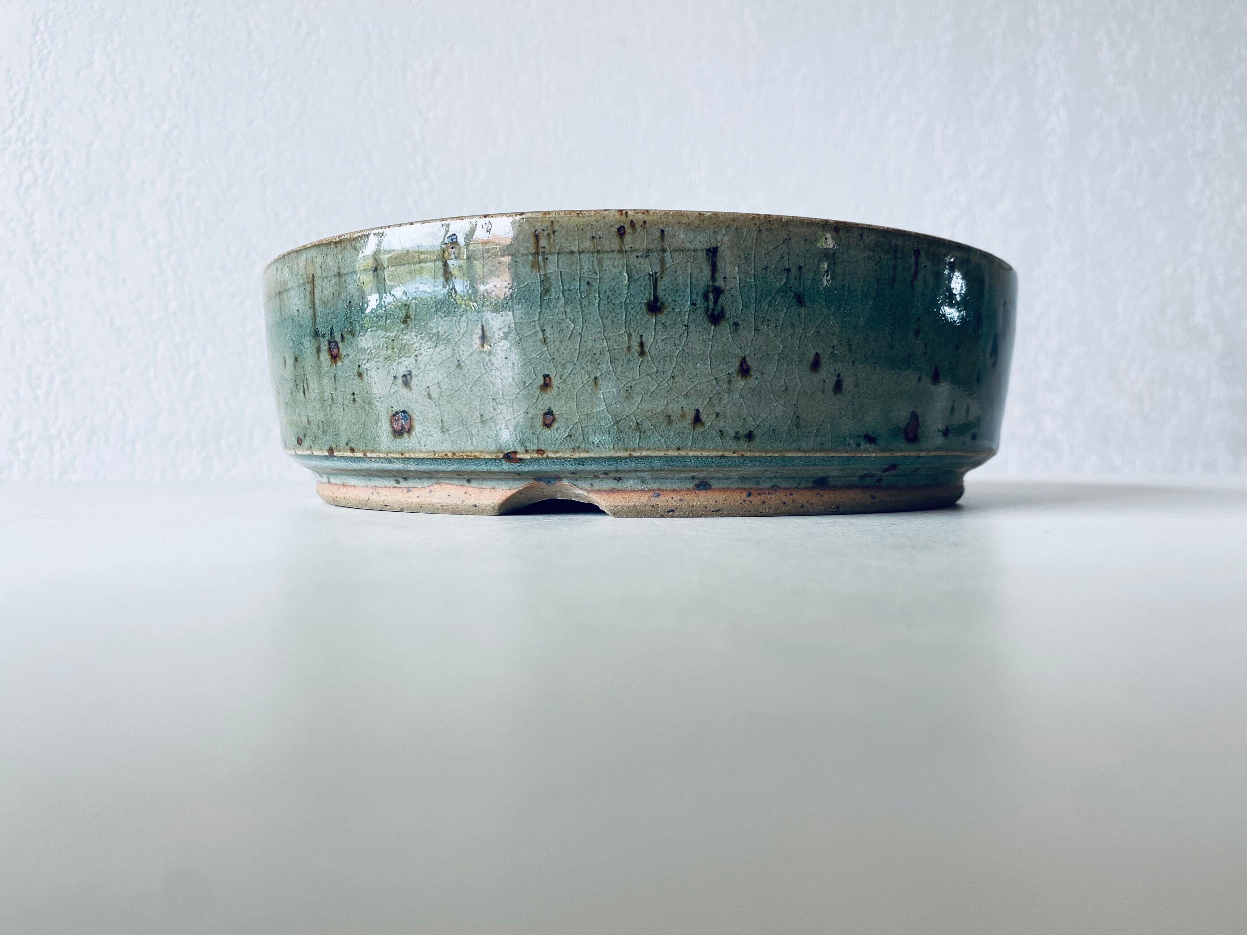 Pierced glazed stoneware cup