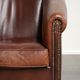 Characterful sheepskin club armchair in a dark cognac colour in English style