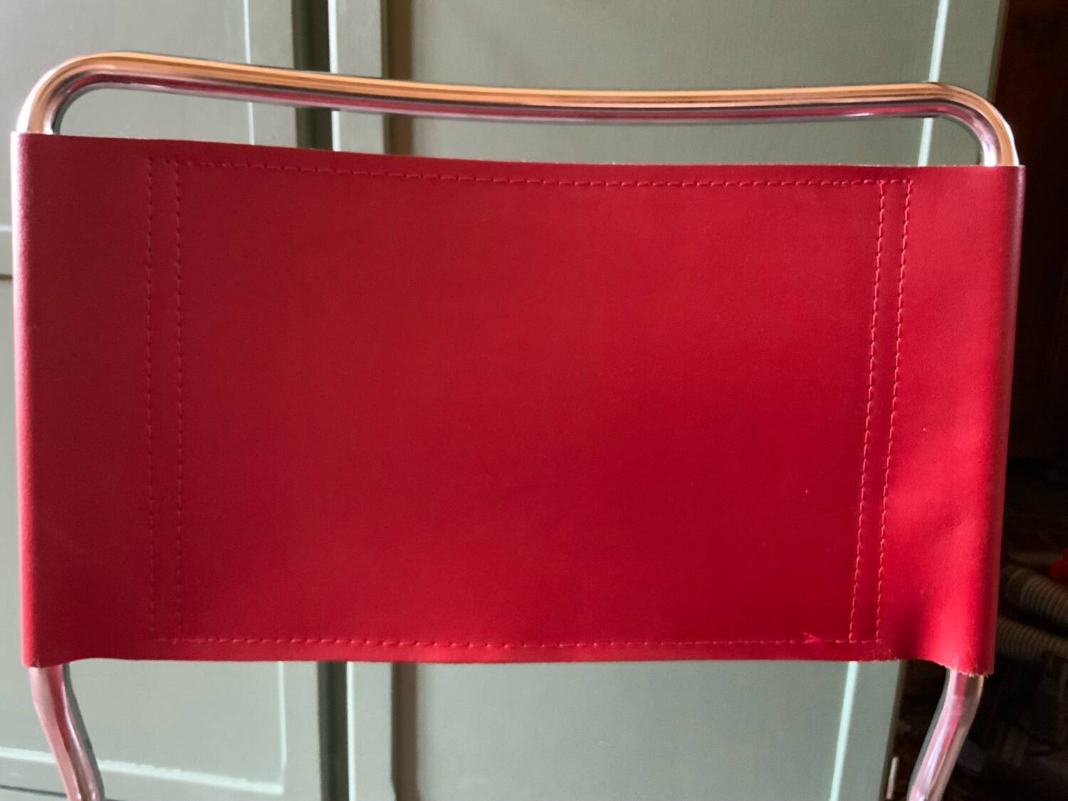 2 tubular chairs in red leather 1970