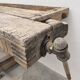 Antique wooden workbench with a vice and drawer.