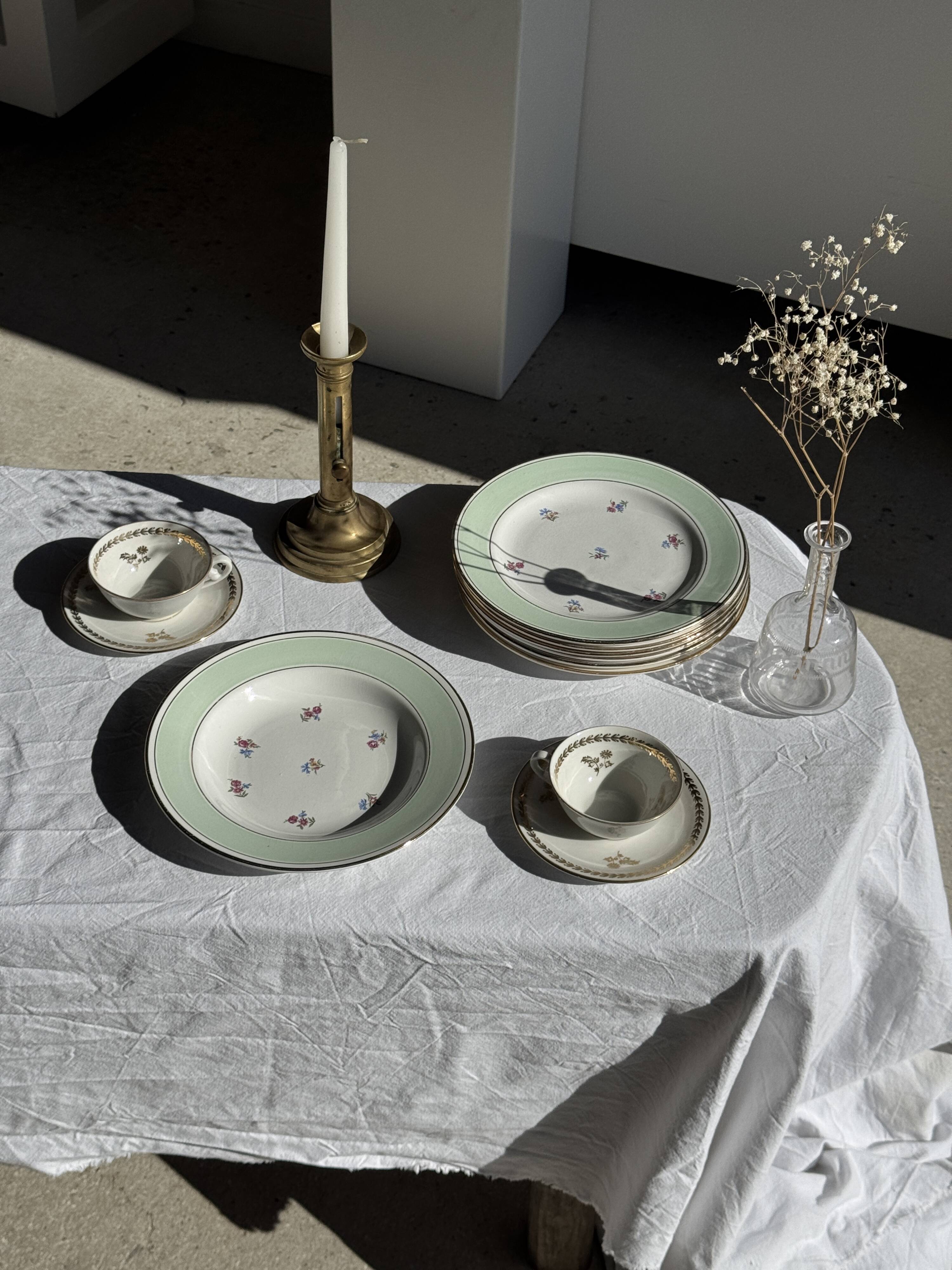 Set of 9 vintage turquoise deep plates with gold trim and pink flowers.