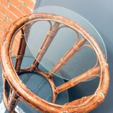 Round table in rattan and glass