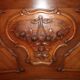 Walnut rocaille bed from the early 20th century.