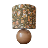 Table lamp with a wooden ball base, floral print in bohemian style.
