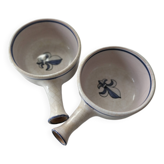 A pair of mini casseroles in crackled earthenware, decorated with a fleur-de-lis.
