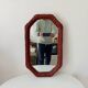 Vintage octagonal mirror in woven rattan.